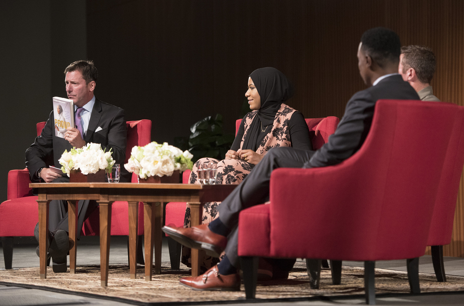 A group of panelists in red chairs at the LBJ Library